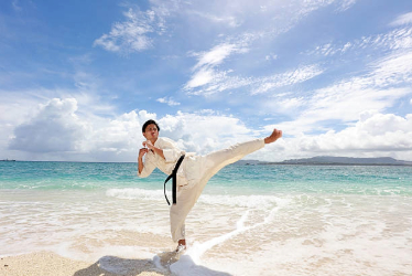 Man doing karate on the beach
